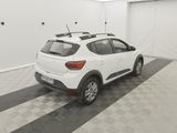 a white car is parked in a garage with a black and white checkered floor