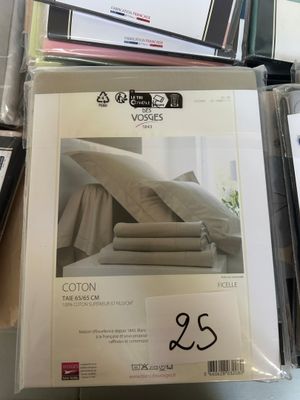 a lot of sheets and pillows on the table