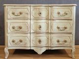 a white chest of drawers on a wooden floor