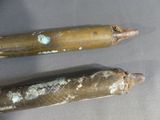 two bullet shells that are sitting on a table