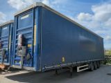 a blue container truck that is parked in a lot