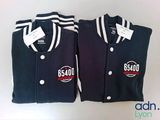 pair of black and white baseball jackets with white stripes on them