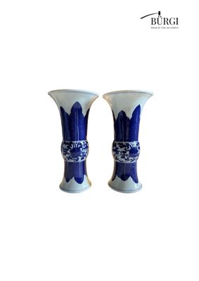 pair of blue and white vases on a white background