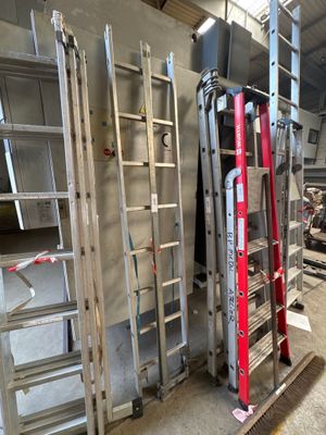 many ladders that are stacked up in a room