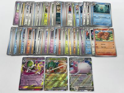 a lot of different pokemon cards on the table