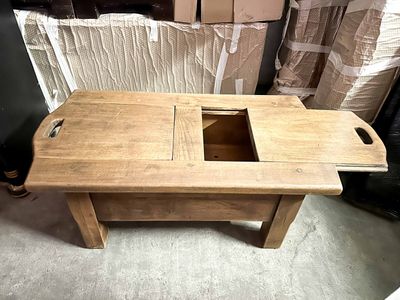 a wooden table with two compartments on top of it