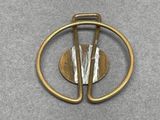 a gold brooch with a circular design on it