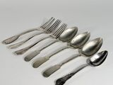six spoons and a fork on a white surface