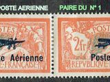 two stamps with a picture of an airplane on them on a black surface
