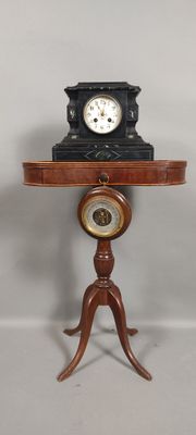a small table with a clock on top of it