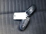 a picture of a car key and remote control on a seat