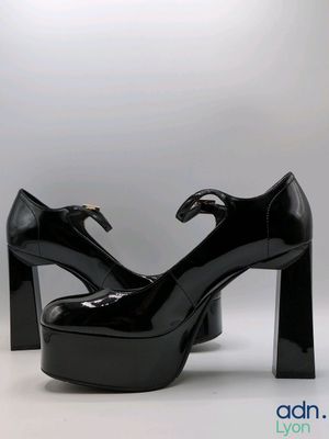 pair of black high heeled shoes on a white background