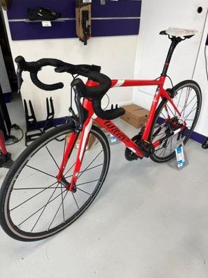 a red bike that is parked in a garage