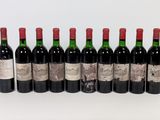 six bottles of wine are lined up in a row on a white surface