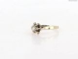 a close up of a diamond ring on a white surface