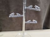 a glass display with birds on it on a table