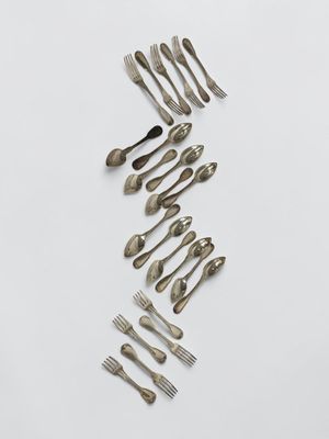 a group of forks and spoons arranged in the shape of a wave