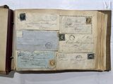 an open book with stamps on it sitting on a table