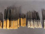 a set of six pairs of chopsticks with a yellow tip