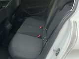 the back of a car with the seats folded down and the door open