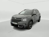 a grey citrole is parked in a white room