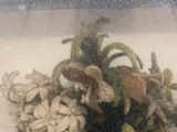 dried flowers in a glass container on a counter top