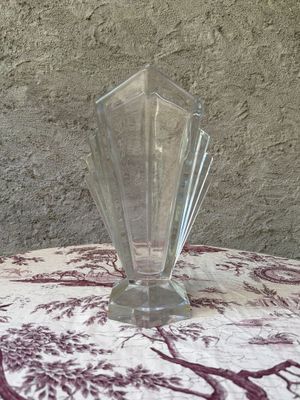 a glass vase sitting on a table with a red and white table cloth