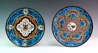 two plates with designs on them are sitting side by side