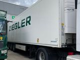 two large trucks parked next to each other in a parking lot