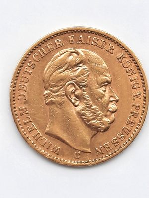 l'image d'une pièce d'or sur laquelle figure le visage d'un homme