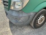 a green truck that is parked on the side of the road