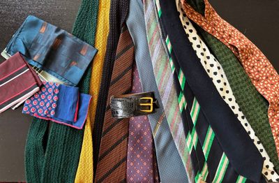 a lot of ties that are hanging on the wall