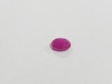 a close up of a single pink stone on a white surface