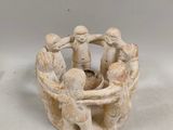 an image of a group of figurines sitting in a bowl