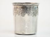 a silver cup that is sitting on a table