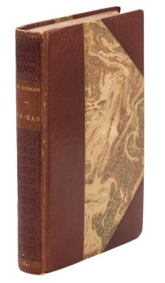 an old book with a brown leather cover and a gold cover