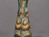 an image of a blue and yellow vase on a gray surface