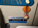 a close up of a sewing machine with a name tag on it