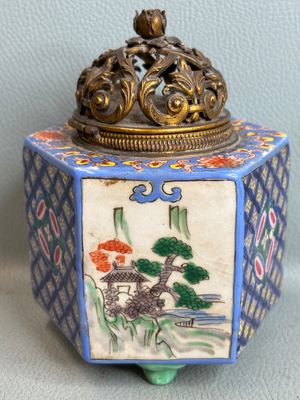 a small box with a painting on it sitting on a table