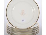 a set of four plates with gold rims and gold trim