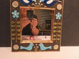 a picture of a woman taking a picture of herself in a picture frame