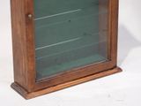 a small wooden display case with glass doors on it