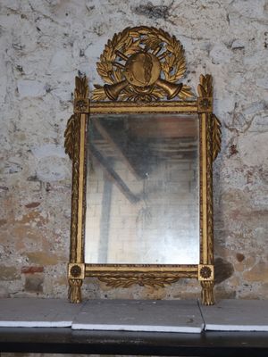a mirror sitting on a table in front of a brick wall