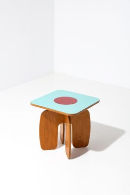 une image représentant une petite table en bois sur laquelle se trouve un point rouge