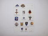 a bunch of badges on a piece of paper on the wall