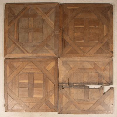 four pieces of wood on the wall of a room