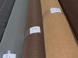 a lot of different colors of fabric on the floor