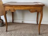 a small wooden table with a glass top on the floor