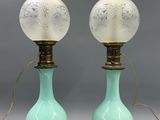 pair of green and white glass lamps on wooden bases