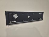 a picture of a black metal sign mounted on a wall